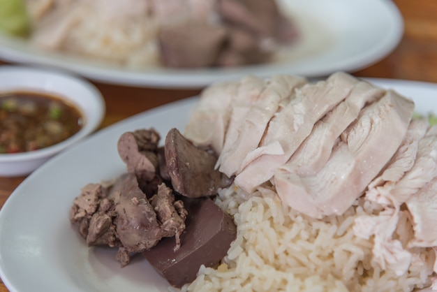 Rice steamed with chicken soup (hainanese chicken rice) with cucumber