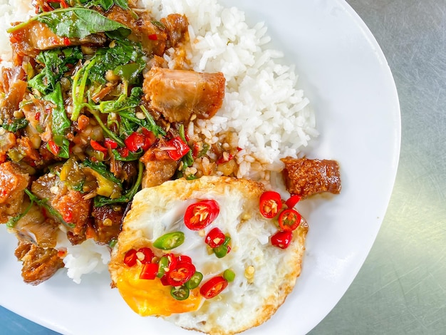 Rice topped with crispy pork belly with Thai basil and fried egg