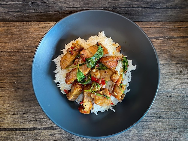 Rice topped with crispy pork belly with Thai basil