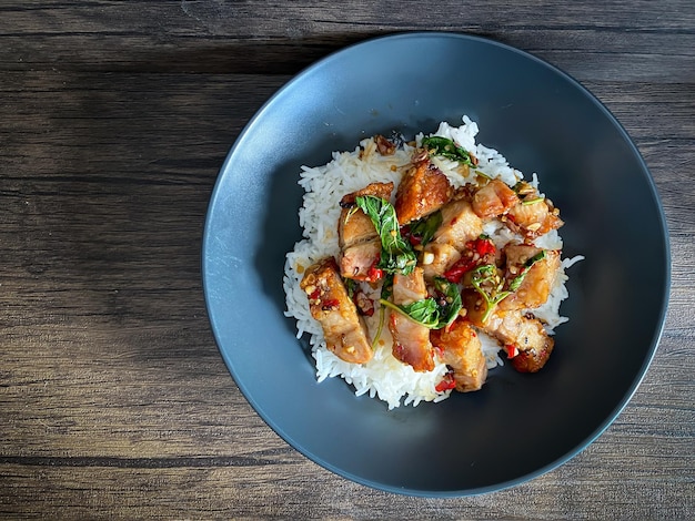 Rice topped with crispy pork belly with Thai basil