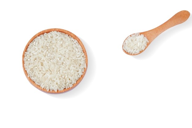 Rice with wooden bowl and wooden spoon isolated on white background,Top view