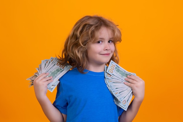 Rich child with dollars Lottery cashback win big money isolated yellow background