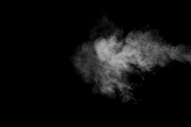 A rich swirling horizontal vapor isolated on a black background for overlaying on your photos Fragment of horizontal steam Abstract smoky background design element