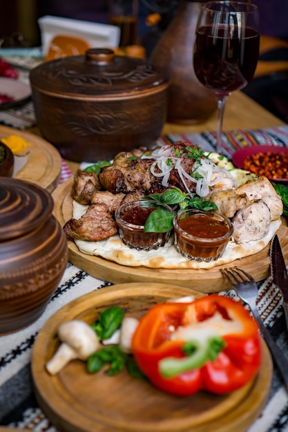 The richly laid table dishes of Georgian cuisine, lots of delicious food,wine,fruits and roasted meat