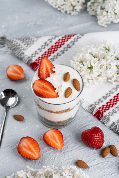 Ricotta dessert with fresh strawberries. Healthy breakfast of yogurt, strawberry and almonds