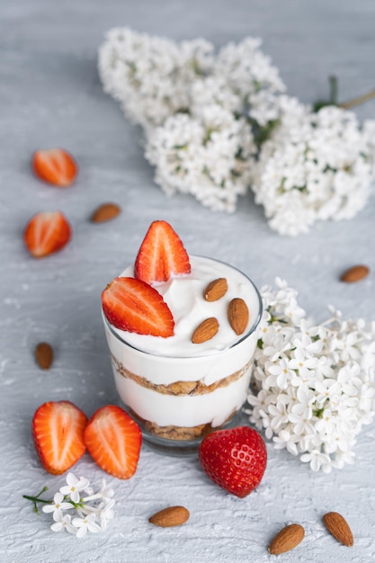 Ricotta dessert with fresh strawberries. Healthy breakfast of yogurt, strawberry and almonds