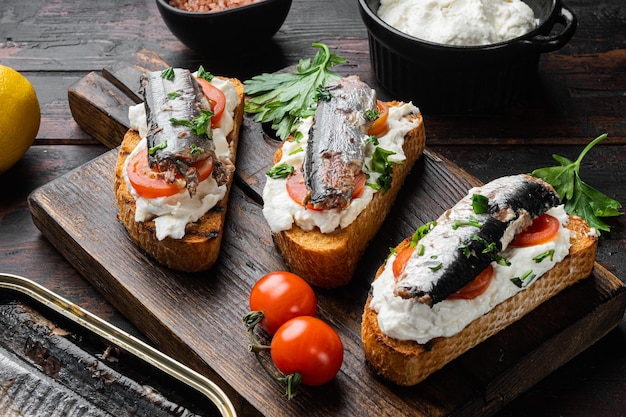 Ricotta sardine toast set, on old dark  wooden table background