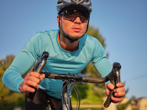 Ride every day young man professional cyclist wearing sportswear and protective helmet looking