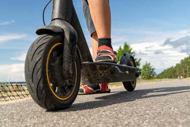 Photo rider enjoys the fresh air while using an electric scooter outdoors