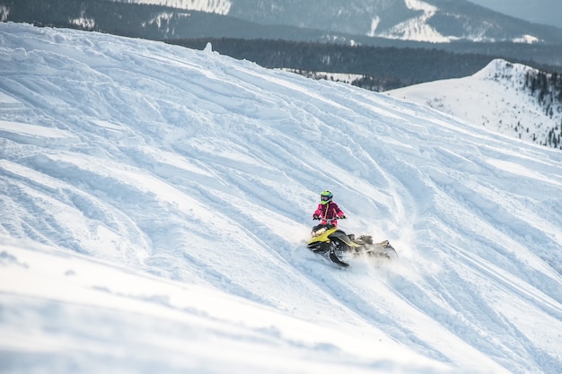 Rider on the snowmobile in the mountains