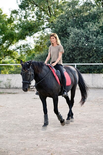 Riding girl are training her black horse