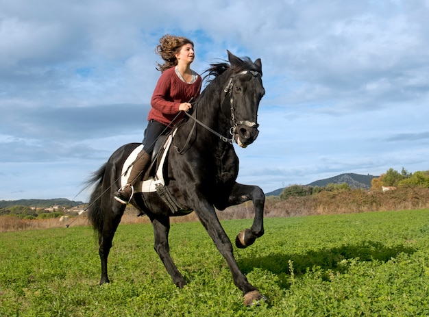 riding girl and black stallion