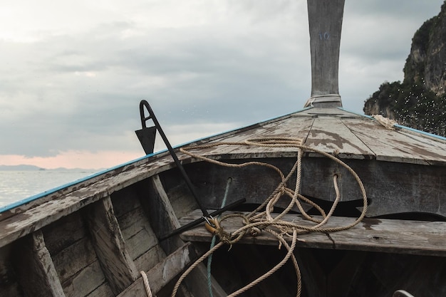 Riding on a traditional Thai longboat on the sea