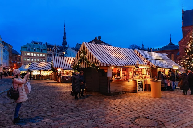 Riga, Latvia - December 28, 2017: People and Christmas market on Dome square in winter Riga in Latvia.