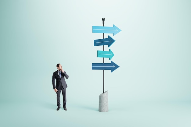 Photo right choice dilemma and business strategy direction concept with pensive man in black suit looking at signpost with blue arrows in different direction on abstract light background