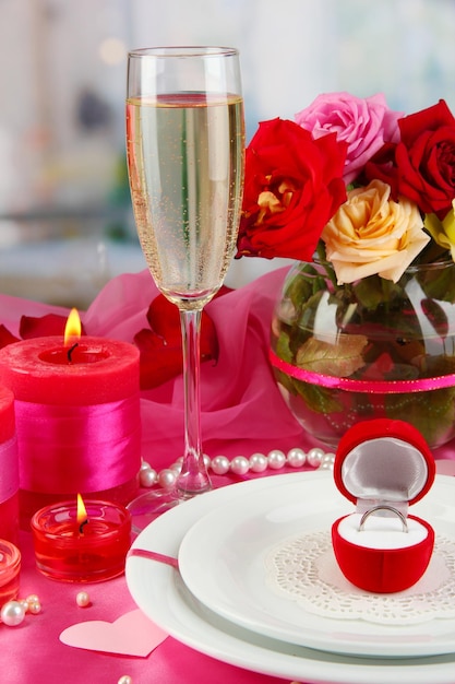 Ring in gift box on celebratory table  of Valentine's Day on room background