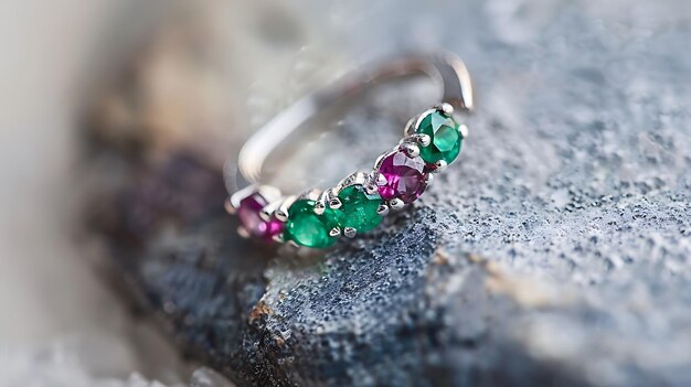 a ring with a green and purple flower and a green garnet