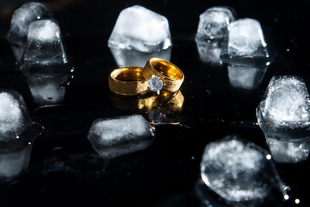 Rings on a dark background. Wedding rings. Jewelry. Ice