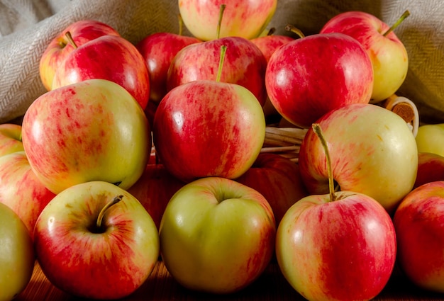 Ripe apples are red and yellow on the table.