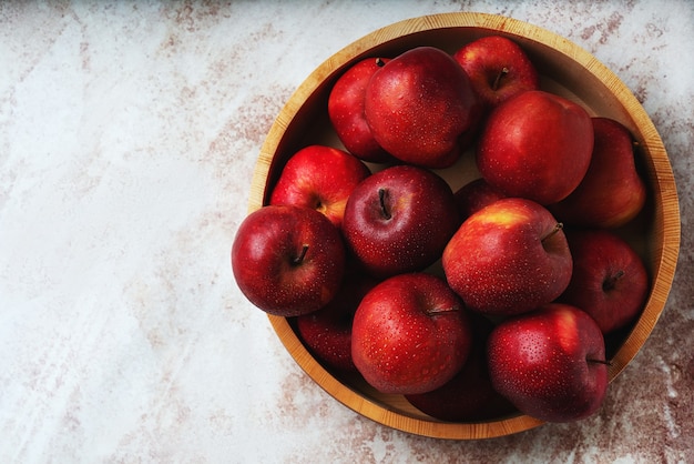 Ripe apples Starking in the wooden bowl. Sustainable storage concept. Top View. Flat lay