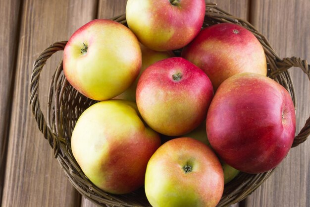 Ripe apples in a wicker basket close-up