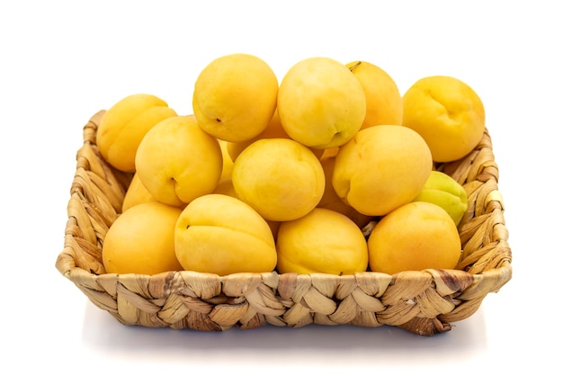 Ripe apricot isolated on white background Fresh and juicy apricots in the basket Organic food close up