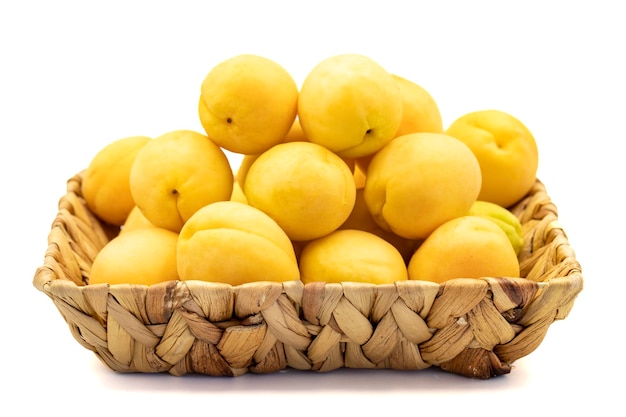 Ripe apricot isolated on white background Fresh and juicy apricots in the basket Organic food close up