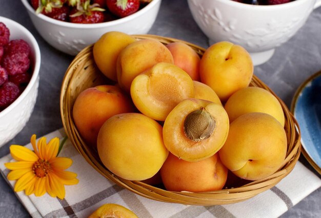 Ripe apricots in a wicker basket summer fruit