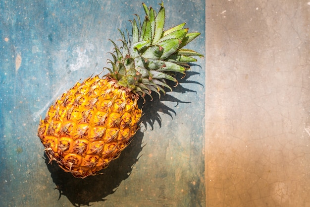 Ripe aromatic pineapple on a concrete table