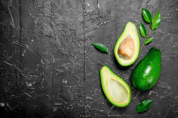 Ripe avocado and cut avocado with bone