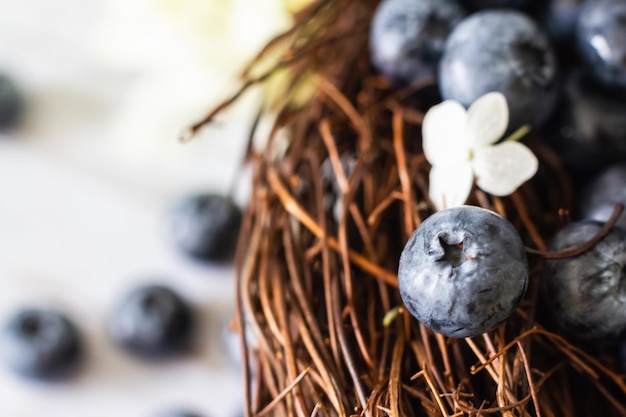 Ripe blueberries Blueberries are in a vine basket with hydrangea flowers nearby