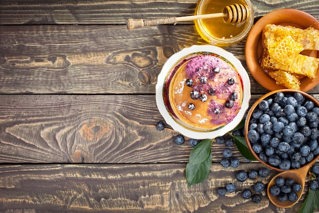 Ripe blueberries, in composition on an old background.