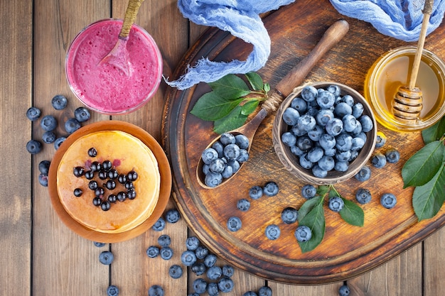 Ripe blueberries, in composition on an old surface.