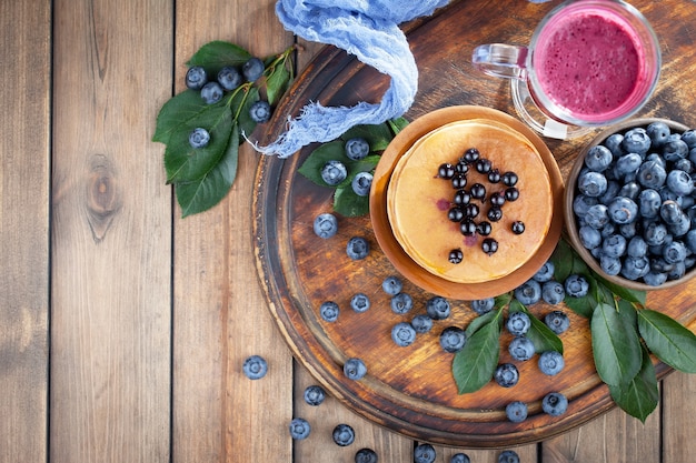 Ripe blueberries, in composition on an old surface.