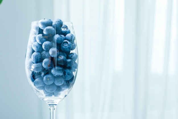 ripe blueberries in a glass goblet. Berries closeup