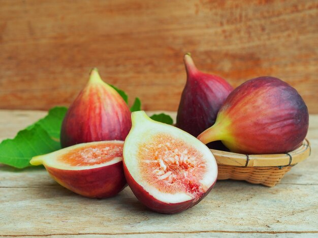 Ripe Brown Turkey fig fruit cut in half on rustic wooden table