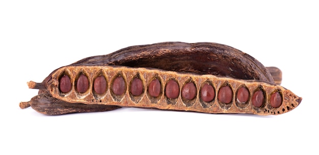 Ripe carob pods and bean isolated on white