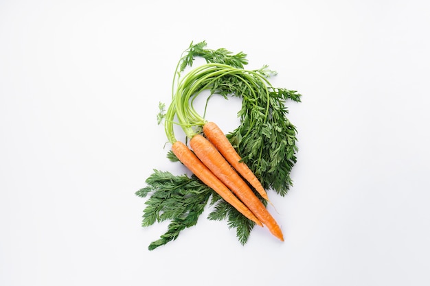 Ripe carrots with leaves isolated