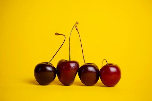 ripe cherries closeup on a yellow background