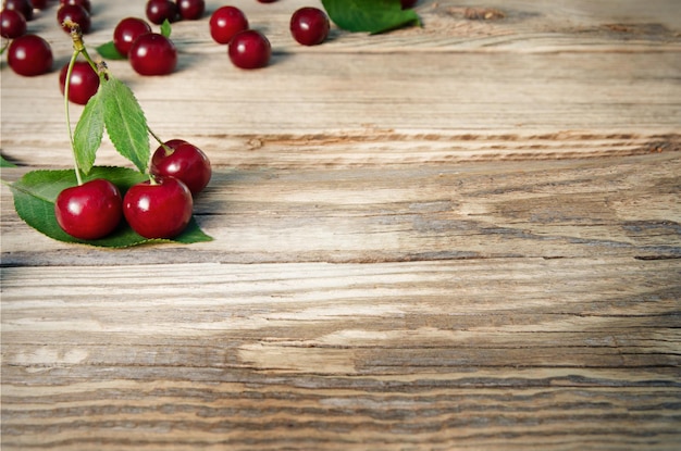 Ripe of cherries on wooden background with copy space