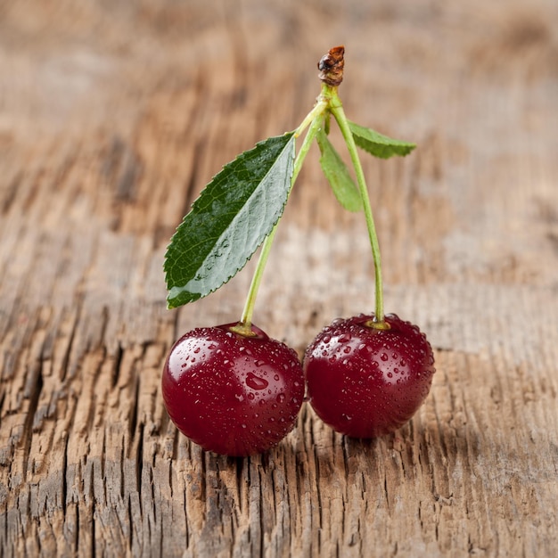 Ripe cherries on wooden table close up