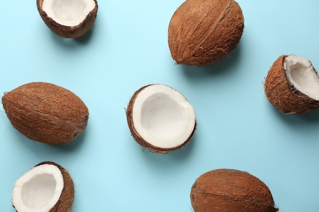 Ripe coconuts on color background