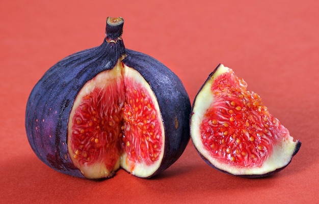 Ripe fig fruit close-up on red