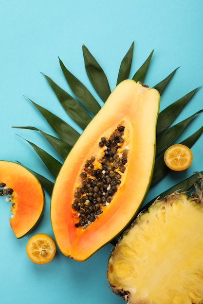 Ripe fresh exotic fruits on blue background.