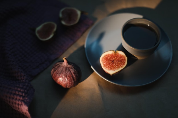 Ripe fresh figs and purple textiles on rustic background flatlay overhead view