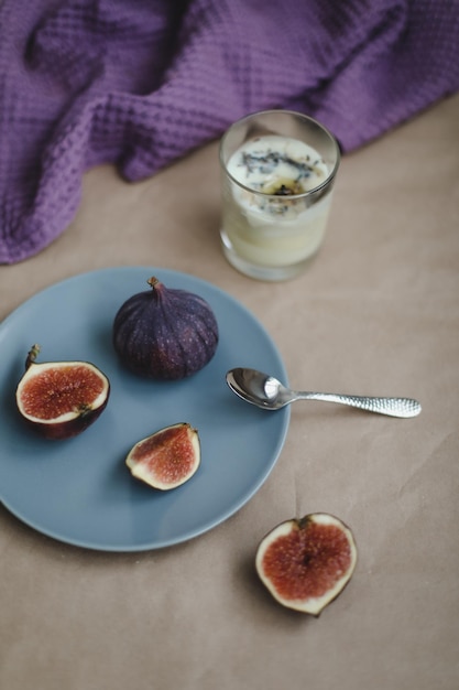 Ripe fresh figs and purple textiles on rustic background flatlay overhead view