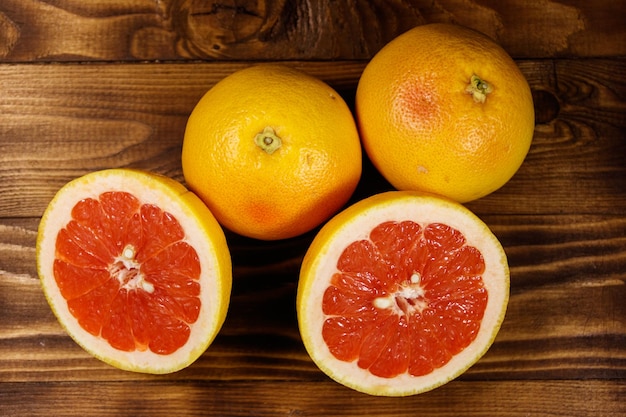 Ripe fresh grapefruits on wooden table