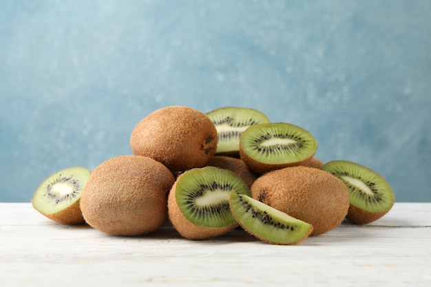 Ripe fresh kiwi on wooden table and space for text