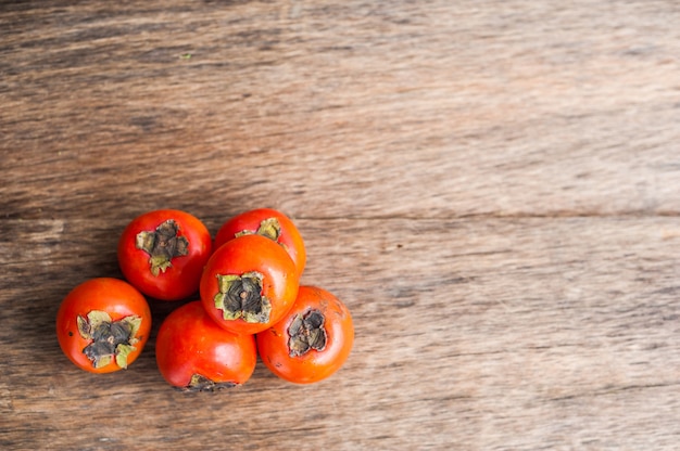 Ripe fresh persimmon on wood board