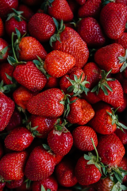 Ripe fresh strawberries close-up in a container for sale. Healthy diet.